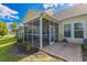 Exterior view of a screened-in patio, showcasing a relaxing outdoor space with patterned concrete and furnishings at 100 Culpepper Way # 1003, Myrtle Beach, SC 29579