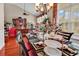 Elegant dining area featuring set table, chandelier, and large windows offering views of the neighborhood at 105 Willow Bay Dr., Murrells Inlet, SC 29576