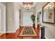 Elegant entryway featuring hardwood floors, stylish rug, transom window, and attractive chandelier at 105 Willow Bay Dr., Murrells Inlet, SC 29576
