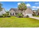 Charming brick home featuring well-manicured lawn and lush landscaping with mature palms in desirable neighborhood at 105 Willow Bay Dr., Murrells Inlet, SC 29576