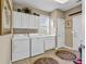 Laundry room with washer, dryer, cabinets, and a utility sink at 105 Willow Bay Dr., Murrells Inlet, SC 29576