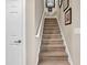 Carpeted staircase features a white handrail and framed artwork at 105 Willow Bay Dr., Murrells Inlet, SC 29576