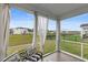 Covered back porch with outdoor furniture and a picturesque view of the backyard and neighboring homes at 1078 Saltgrass Way, Myrtle Beach, SC 29588