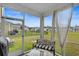 Cozy back porch with outdoor seating and a view of the lush green backyard at 1078 Saltgrass Way, Myrtle Beach, SC 29588