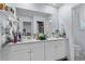 Bright bathroom featuring double sinks, white cabinetry, and large mirror at 1078 Saltgrass Way, Myrtle Beach, SC 29588