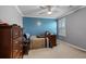 This bedroom features cool colors, a ceiling fan, and ample natural light, creating a serene and inviting space at 1078 Saltgrass Way, Myrtle Beach, SC 29588
