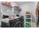 Functional laundry room with modern machines, storage shelves, and a clean, organized space at 1078 Saltgrass Way, Myrtle Beach, SC 29588