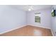 Bedroom featuring light purple walls, hardwood floors, and a bright window at 1125 Blue Stem Dr. # 29F, Pawleys Island, SC 29585