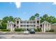 Low angle view of a condominium with beautiful trees and landscaping at 1125 Blue Stem Dr. # 29F, Pawleys Island, SC 29585