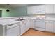 Bright kitchen features white cabinetry, appliances, laminate countertops and flooring at 1125 Blue Stem Dr. # 29F, Pawleys Island, SC 29585