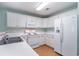 Kitchen features white appliances, wood floors and white cabinets at 1125 Blue Stem Dr. # 29F, Pawleys Island, SC 29585