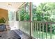Relaxing screened balcony features a dining table, chairs, and picturesque views of the verdant trees at 1125 Blue Stem Dr. # 29F, Pawleys Island, SC 29585
