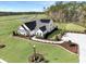 Aerial view of the home showing manicured lawn and pristine golf course in the background at 115 Northbrook Dr, Murrells Inlet, SC 29576