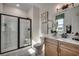 Well-lit bathroom featuring a glass-enclosed shower, toilet, vanity with white countertop and framed art at 115 Northbrook Dr, Murrells Inlet, SC 29576