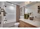Bright bathroom featuring a shower-tub combo, modern vanity with quartz countertop, and decorative accents at 115 Northbrook Dr, Murrells Inlet, SC 29576