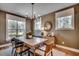 Elegant dining room with natural light, modern chandelier, and stylish furniture, perfect for hosting gatherings at 115 Northbrook Dr, Murrells Inlet, SC 29576