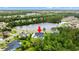 Distant aerial view of a home and its in-ground pool near a lake at 116 Sago Palm Dr., Myrtle Beach, SC 29579