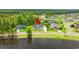 Aerial view of the home in its neighborhood near a lake at 116 Sago Palm Dr., Myrtle Beach, SC 29579