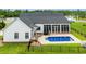 Back of home featuring an in-ground pool, sunroom, and a well-maintained yard at 116 Sago Palm Dr., Myrtle Beach, SC 29579