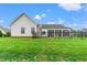 View of the back exterior showcasing a fenced yard and sunroom at 116 Sago Palm Dr., Myrtle Beach, SC 29579