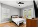 Cozy bedroom with French doors, a ceiling fan, and ample natural light streaming through the windows at 116 Sago Palm Dr., Myrtle Beach, SC 29579
