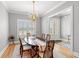 Elegant dining room with a wood table, chandelier lighting, and windows with wooden shutters at 116 Sago Palm Dr., Myrtle Beach, SC 29579