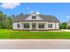 Charming single-Gathering home with a covered front porch, manicured lawn, and traditional architectural style at 116 Sago Palm Dr., Myrtle Beach, SC 29579