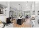 Open-concept kitchen flowing into the living and dining area with modern pendant lights and light countertops at 116 Sago Palm Dr., Myrtle Beach, SC 29579