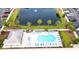 Resort-style pool area with lounge chairs, tables, and umbrellas surrounded by mature landscaping and a nearby parking area at 118 Birch N Coppice Dr. # 6, Surfside Beach, SC 29575