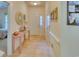 Inviting hallway with tile flooring, a decorative mirror, and a stylish table with a floral arrangement at 118 Birch N Coppice Dr. # 6, Surfside Beach, SC 29575