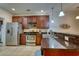 Modern kitchen with stainless steel appliances, dark wood cabinets, granite countertops, and tiled floors at 118 Birch N Coppice Dr. # 6, Surfside Beach, SC 29575