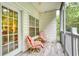 Relaxing screened porch with patterned tile flooring, comfortable seating, and views of the surrounding greenery at 118 Birch N Coppice Dr. # 6, Surfside Beach, SC 29575