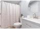 Bright bathroom featuring a shower over tub with neutral tone tile, and brushed gold fixtures at 1210 N Ocean Blvd. # 104, Surfside Beach, SC 29575