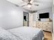 Comfortable bedroom features a ceiling fan, a large dresser, and a flat screen TV at 1210 N Ocean Blvd. # 104, Surfside Beach, SC 29575