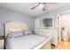 Cozy bedroom with a comfortable bed, dresser with large mirror, and a door to the bathroom at 1210 N Ocean Blvd. # 104, Surfside Beach, SC 29575