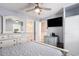 Comfortable bedroom features a ceiling fan, dresser with large mirror, and flat screen TV at 1210 N Ocean Blvd. # 104, Surfside Beach, SC 29575