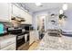 Well-equipped kitchen featuring granite countertops, stainless steel appliances, and direct access to laundry at 1210 N Ocean Blvd. # 104, Surfside Beach, SC 29575