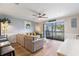 Bright living room with a comfy sofa, stylish decor, and sliding glass doors to the balcony at 1210 N Ocean Blvd. # 104, Surfside Beach, SC 29575