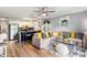 Open-concept living room featuring modern decor, a comfortable sectional sofa, and a stylish kitchen island at 1210 N Ocean Blvd. # 104, Surfside Beach, SC 29575