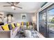 Bright living room with a comfortable sectional couch, glass coffee table, and balcony access at 1210 N Ocean Blvd. # 104, Surfside Beach, SC 29575