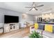 Spacious living room featuring a comfortable sectional, kitchen island, and entertainment center with a large TV at 1210 N Ocean Blvd. # 104, Surfside Beach, SC 29575