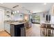 Open-concept living area with a modern kitchen, comfortable seating, and access to an outdoor balcony at 1210 N Ocean Blvd. # 104, Surfside Beach, SC 29575