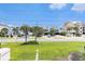 Charming street view of coastal homes surrounded by swaying palm trees, creating a relaxed beach community atmosphere at 1210 N Ocean Blvd. # 104, Surfside Beach, SC 29575