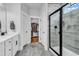 A luxurious bathroom features a tiled shower, double doors to the closet, and modern fixtures at 1216 Newell Dr, Myrtle Beach, SC 29588