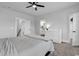 Bedroom with carpet floors and a ceiling fan provides access to the ensuite bathroom and walk-in closet at 1216 Newell Dr, Myrtle Beach, SC 29588