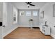 Bright bedroom with wood flooring, multiple windows, and space for an office setup and storage at 1216 Newell Dr, Myrtle Beach, SC 29588