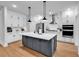 Spacious kitchen features a large island with white countertop, stainless steel appliances, and modern pendant lighting at 1216 Newell Dr, Myrtle Beach, SC 29588