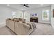 Bright living room with plush sectional sofa, ceiling fan and media center with large screen TV at 1216 Newell Dr, Myrtle Beach, SC 29588