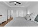 Spacious primary bedroom features a ceiling fan, tray ceiling, and access to ensuite bathroom and walk-in closet at 1216 Newell Dr, Myrtle Beach, SC 29588