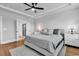 A bright bedroom with tray ceiling and ceiling fan, leading to a ensuite bathroom at 1216 Newell Dr, Myrtle Beach, SC 29588